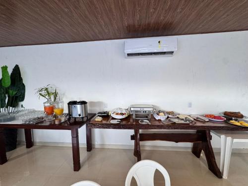 two tables in a room with food on them at Isadora Pousada in Salinópolis