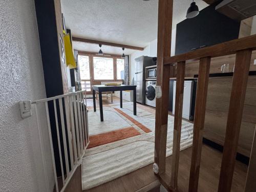 a hallway with a stairway leading to a living room at Appartements pied des pistes - Résidence Mongie - Tourmalet in La Mongie