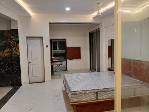 a bedroom with a bed in a room at Hare Krishna Beach Resort in Srīvardhan