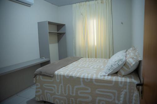 a bedroom with a bed with two pillows on it at Casa Bosque da Serra in Crato