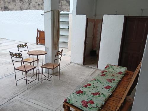 a bench with a table and chairs and a table and chairs at Casa familiar con piscina privada in Agua de Dios