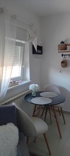 a living room with a table and two chairs at Barbara in Bjelovar