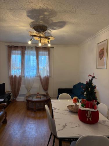 a living room with a christmas tree on a table at Appartement rez de chaussée coup de cœur Confort et charme Parking gratuit in Roanne