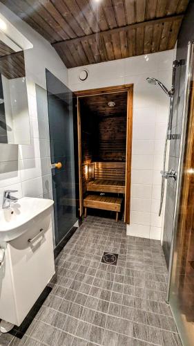a bathroom with a shower and a sink at North Frontier Cabins in Saariselka