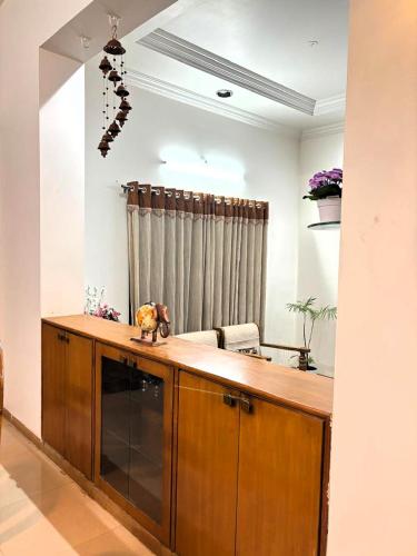a kitchen with a wooden counter top in a room at Tranquil Trails-Sharvari Villa-Nashik in Nashik