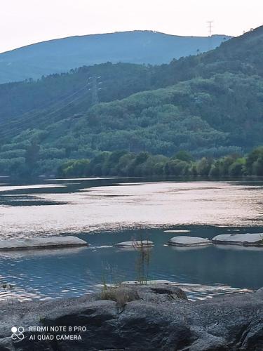 a large body of water with mountains in the background at A casa da Igrexa in Ribadavia