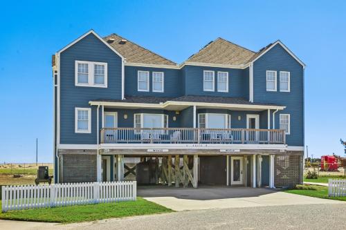 a large blue house with a white fence at CAC-22A - Whale in Buxton