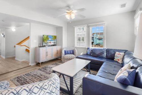 a living room with a blue couch and a tv at CAC-18A - Seahorse in Buxton