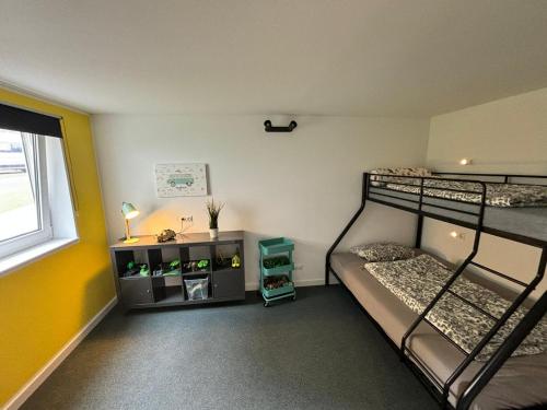 a bedroom with two bunk beds and a window at Family Beach Appartement Laboe in Laboe