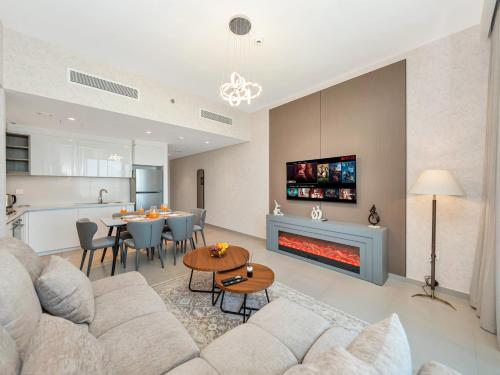a living room with a couch and a fireplace at BRAND-NEW 1BR in DOWNTOWN I Direct DUBAI MALL Access I Balcony & Stunning Pool in Dubai