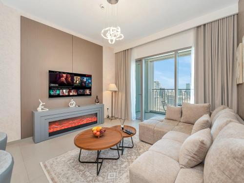 a living room with a couch and a fireplace at BRAND-NEW 1BR in DOWNTOWN I Direct DUBAI MALL Access I Balcony & Stunning Pool in Dubai
