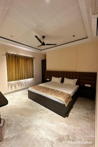 a bedroom with a bed and a ceiling at Hotel Kingdom - 3 minutes From Golden Temple in Amritsar