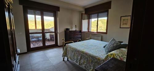 a bedroom with a bed and two windows at Raggio Di Sole in Cosenza