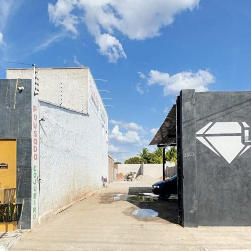 a building with a door with a arrow painted on it at Pousada Cajueiro in Juazeiro do Norte