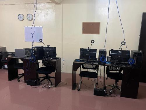 a room with a table with several computers on it at Upskill Coworking Space in Marilao