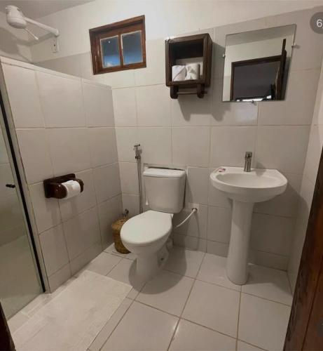 a bathroom with a toilet and a sink at Pousada Lumawê Caraíva in Porto Seguro