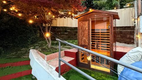 a wooden out house with lights on the stairs at Casa Milla - 15 min from airport, private sauna, terrace and parking in Alzano Lombardo