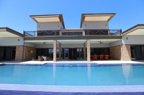 a large swimming pool in front of a building at Naisoso Island Villa - Fiji in Nadi