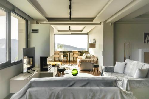 a living room with a large bed and a couch at Elysian Villa by Ski Alure in Arachova