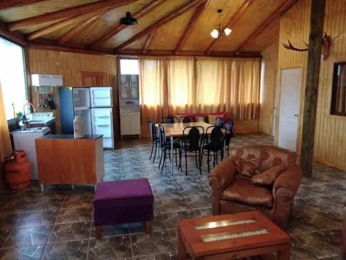 una sala de estar con un sofá y una mesa en Gran cabaña en playas ILoca, Curico, en Rancura