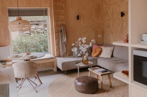 un soggiorno con un divano e un tavolo di De Eikenloft a Heerenveen