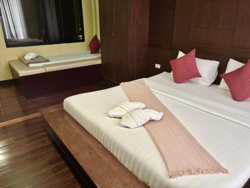 a bedroom with two beds with towels on them at Sabye Bangkok in Bangkok