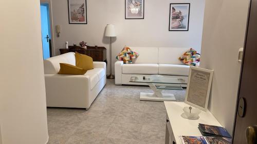 a living room with a white couch and a table at Perla Marina - Salerno in Salerno