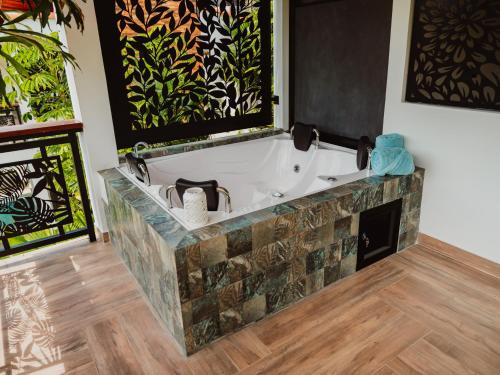 a bathroom with a bath tub in a room at Antara Resort in Alcalá