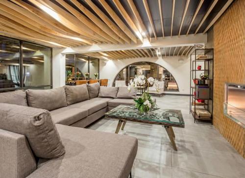 a living room with a couch and a table at Ramada by Wyndham Austin South in Austin