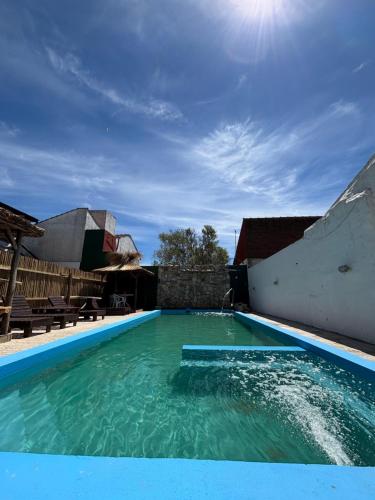 Costa Clara Hotel في سانتا كلارا ديل مار: حمام سباحة بمياه زرقاء في منزل