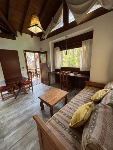 a bedroom with two beds and a table in it at Ayrampo in Mar de las Pampas