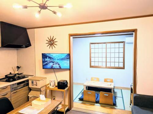 a kitchen with a door open to a kitchen with a stove at Wood River House 門前仲町駅 木場駅 in Tokyo
