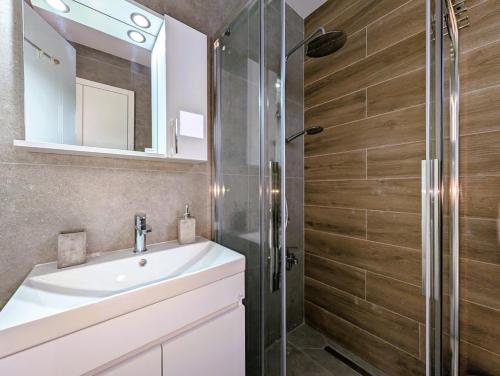 a bathroom with a sink and a shower at Coral Bay Star - Direct sea location in Peyia