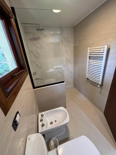 a bathroom with a white sink and a toilet at Ayrampo in Mar de las Pampas