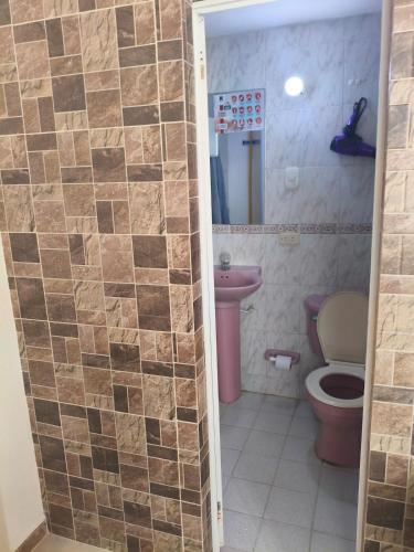 a bathroom with a toilet and a sink at beautiful and cozy studio apartment in San Martín