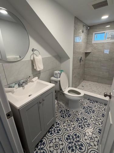 a bathroom with a sink and a toilet and a shower at Vibes Villa in Wildwood