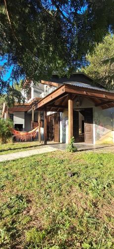 a house with a porch and a grass yard at Pax Costa del Este in Costa del Este