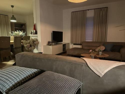 a living room with a couch and a table at Guesthouse Eekhoorn 16 in Kasterlee
