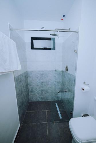 a bathroom with a shower and a toilet at Shan's Comfort Sanctuary in Tatu City