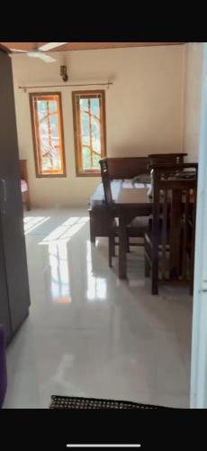 a living room with a table and a couch at 2-Room Apartment in Jaffna