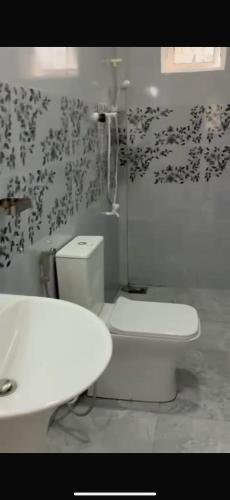 a bathroom with a toilet and a sink at 2-Room Apartment in Jaffna