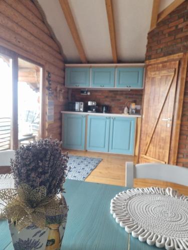 a kitchen with a table with a vase on it at Cabanele Borsa View in Borşa