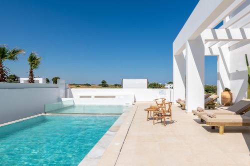 een villa met een zwembad en een patio bij Seapalm Villa - Luxury Pool Retreat - 200m Beach in Lachaniá