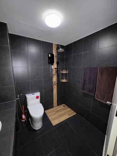 a bathroom with a toilet and a shower at Green Terrace Residence Phuket in Kathu