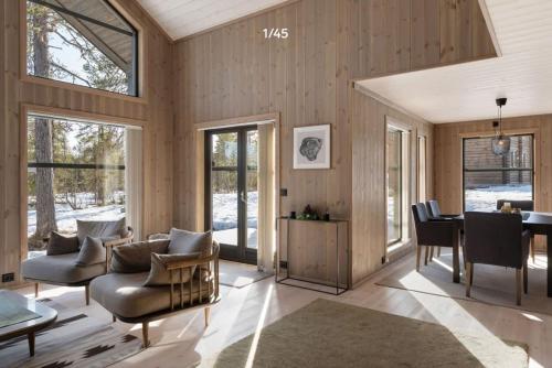 a living room with wood paneling and a dining room at Trysilfjell hytteomrade 2124 by Vacation Trysil in Hovi