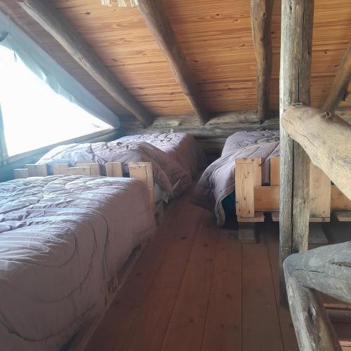 En eller flere senge i et værelse på Cabaña Eluney