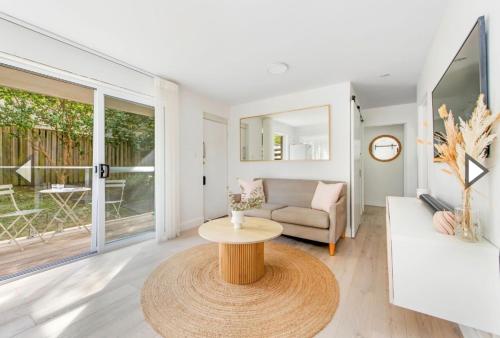 a living room with a table and a couch at Freshwater Coastal Retreat 3BR Apartment in Freshwater