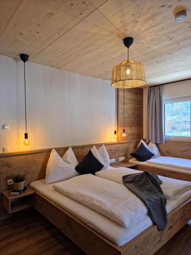 a bedroom with two beds and a chandelier at Lake View Lodge in Flachau