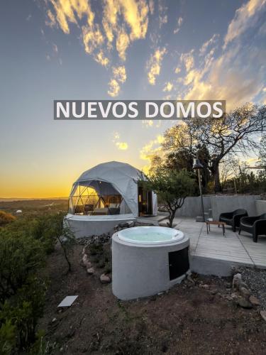 a luxury house with a yurt with the words nucos domos at Aguas Claras in Capilla del Monte