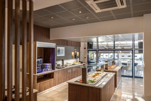 a restaurant with a buffet line with food at Lantiana Gardens ApartHotel in Protaras